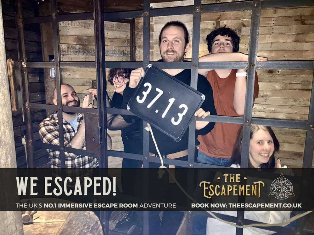 Five adults standing in an escape room built like a pirates ship